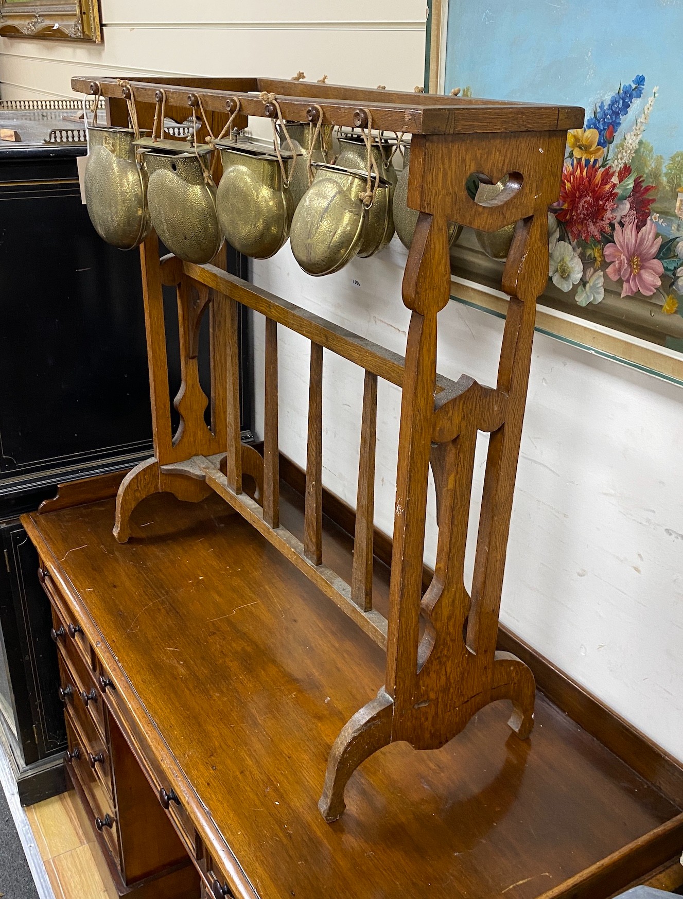 An Arts & Crafts oak and brass Glockenspiel by Plant and Percy, width 78cm, height 79cm